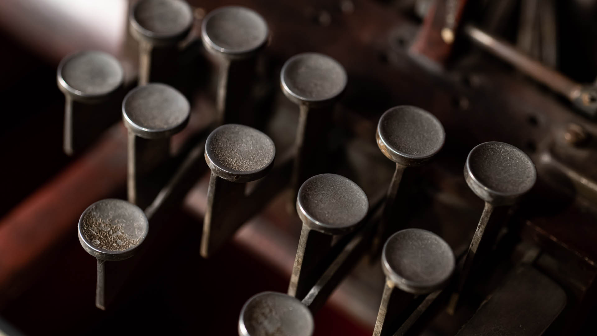 Closeup of metal keys on a red New York Point stereograph machine